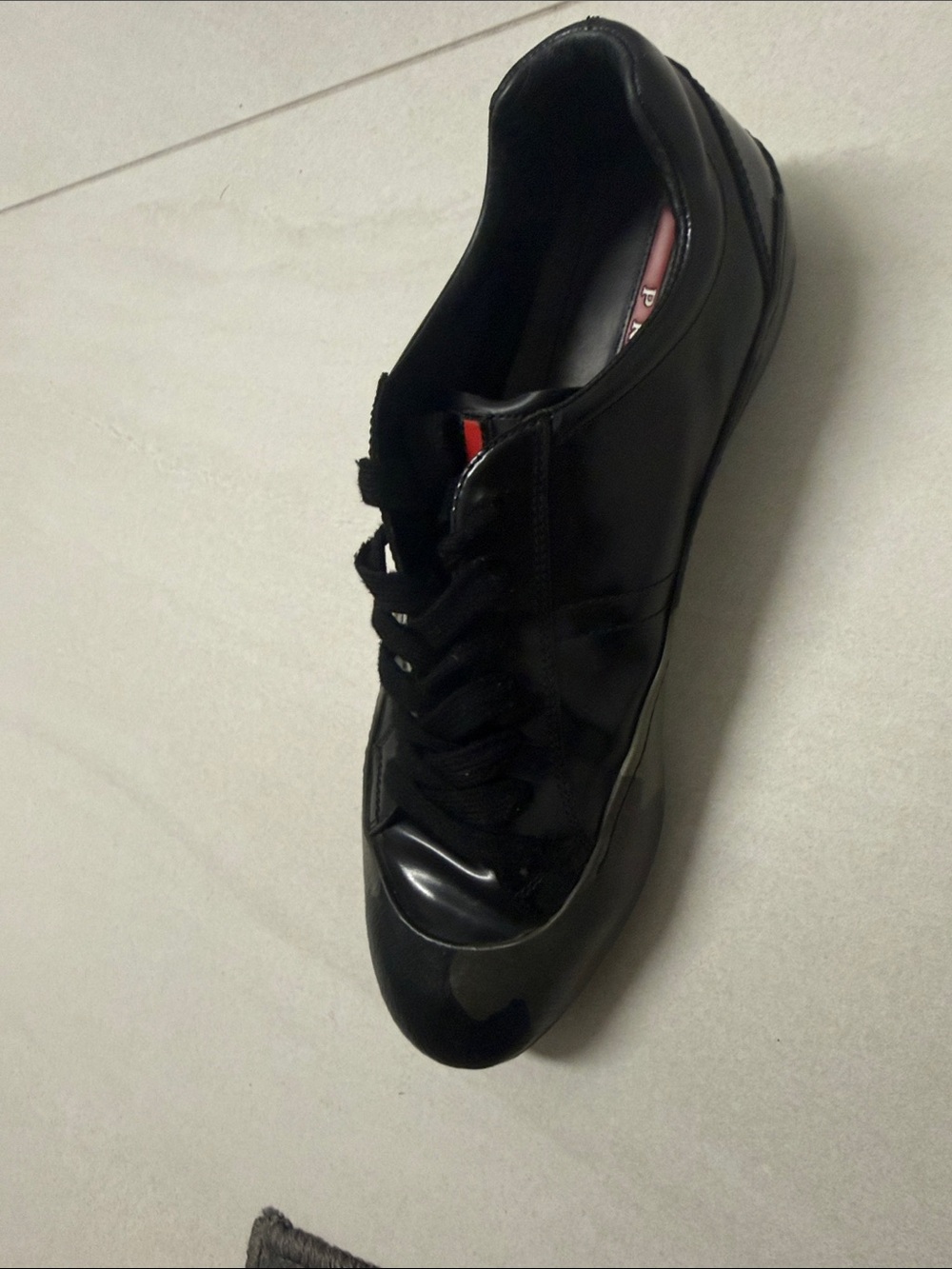 Prada Black Low-Top Leather Sneaker with Red Tongue Accent